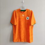 Domowa koszulka Wybrzeżę Kośći Słoniowej z 2006 roku w kolorze pomarańczowym w rozmiarze L