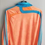 Trzecia koszulka piłkarska w wersji player issue Olympique Marsylia z sezonu 2007-08 w kolorze pomarańczowym marki Adidas.